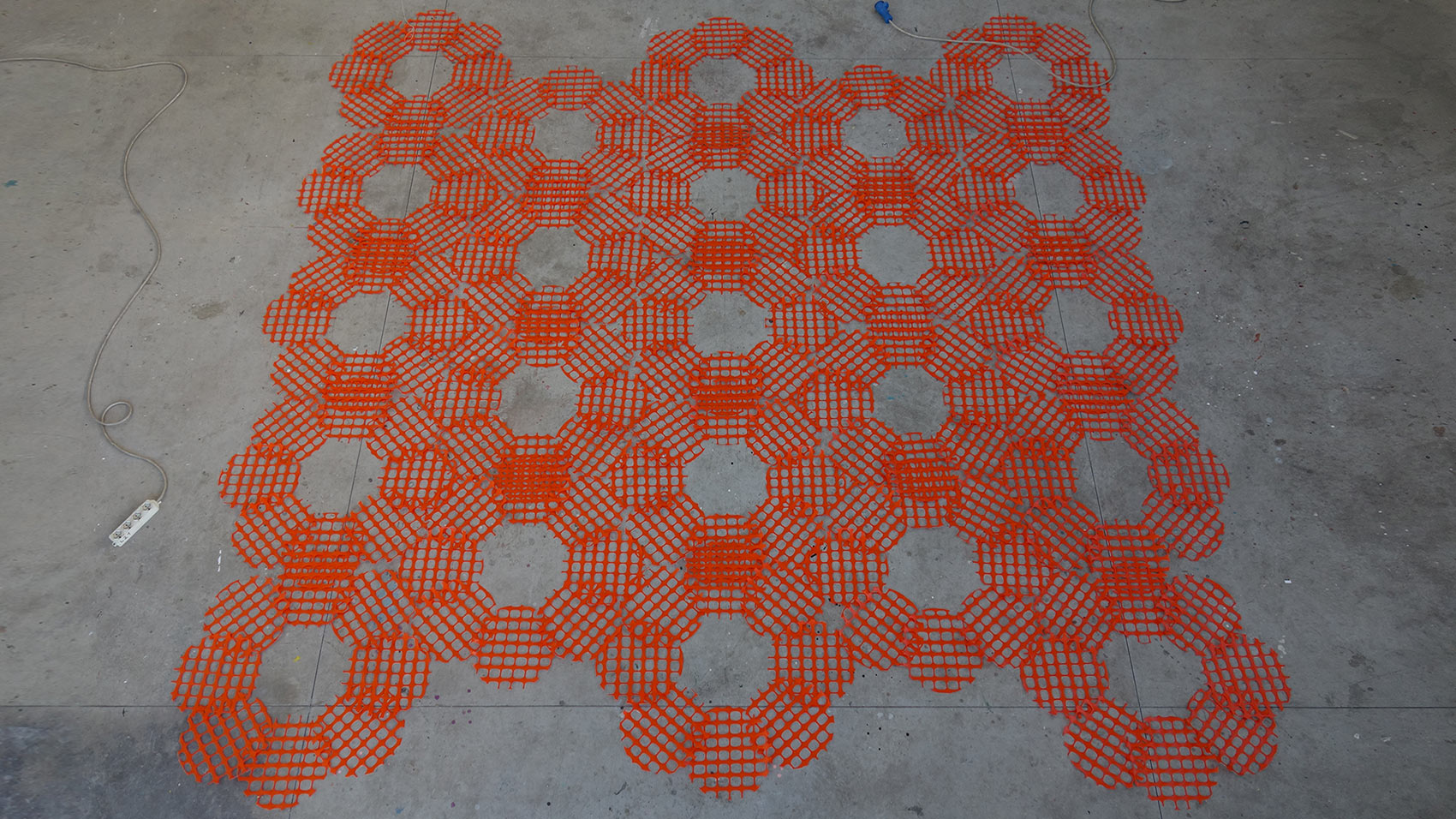 'Relative restrictions', 2017. 180 circles pieces of orange plastic barrier. BAU, Viareggio